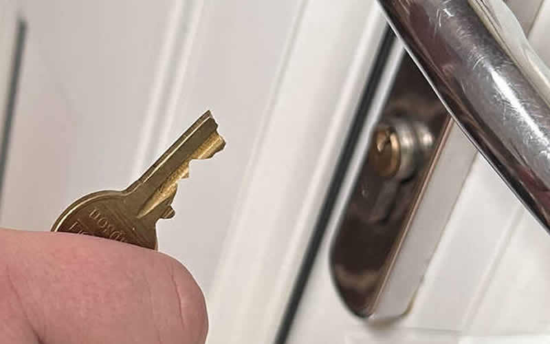 Snapped key next to a uPVC door handle and cylinder lock