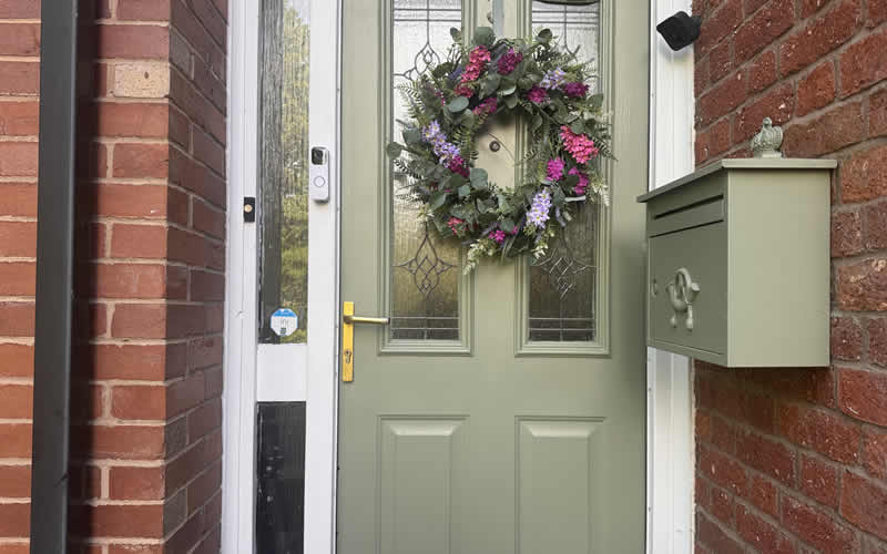 Green composite front door with new gold handle