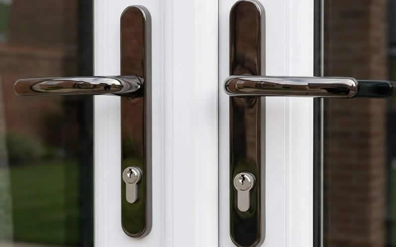 Pair of chrome handles with euro cylinders on French doors