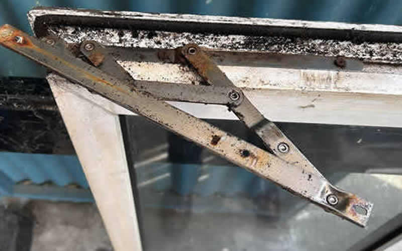 Rusted uPVC window friction hinge before replacement