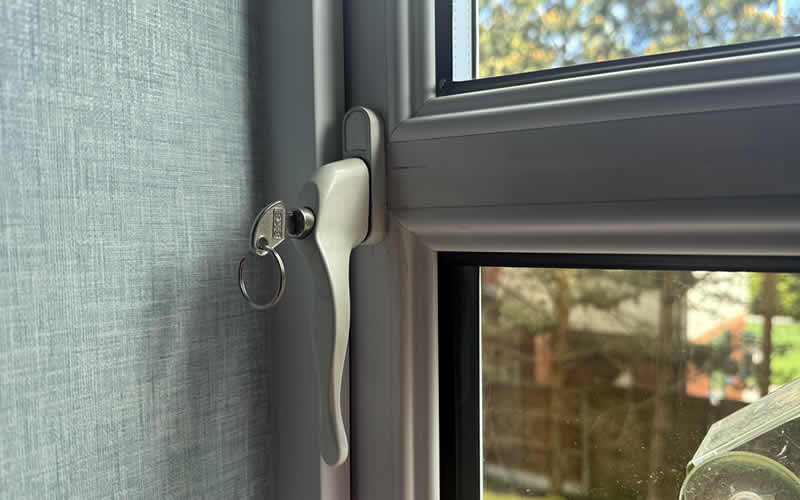 New white locking handle on a uPVC window