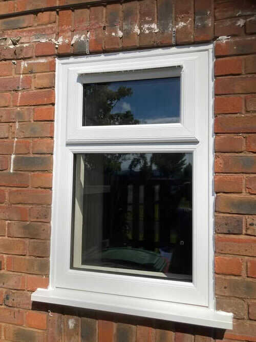White uPVC window in a brick wall after hinge repair
